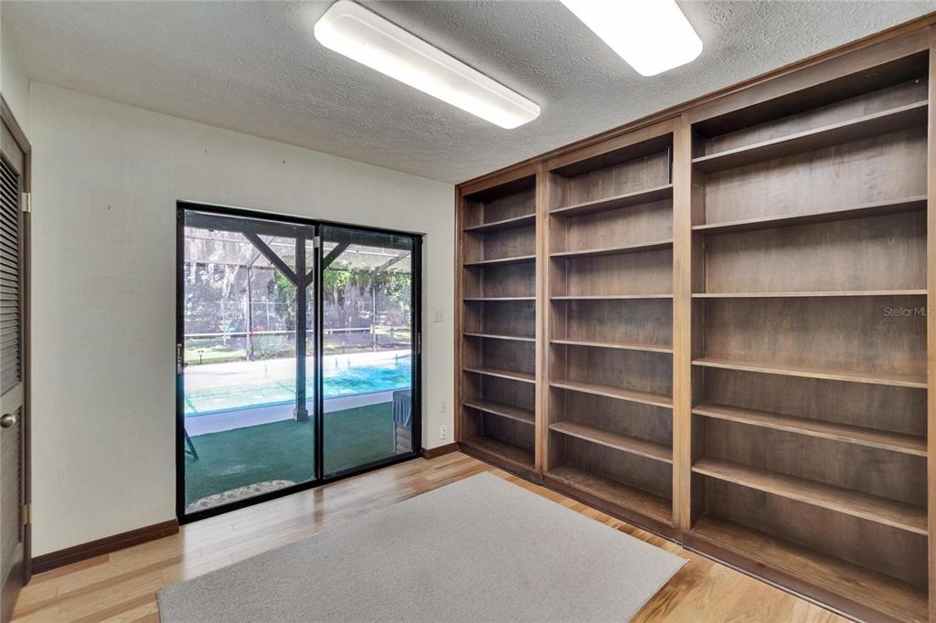3102 East Trapnell Road Plant City, FL 33566 - Photo 87 of 100 a view of an empty room with wooden floor and a window