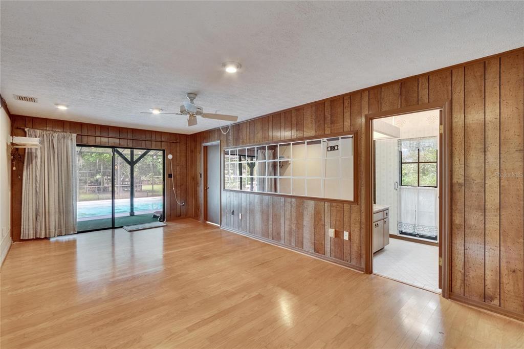 3102 East Trapnell Road Plant City, FL 33566 - Photo 93 of 100 a view of an empty room with wooden floor and a window