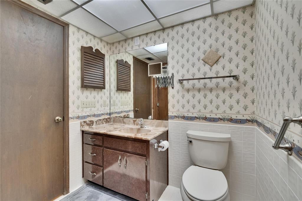 3102 East Trapnell Road Plant City, FL 33566 - Photo 99 of 100 a bathroom with a granite countertop toilet sink and mirror