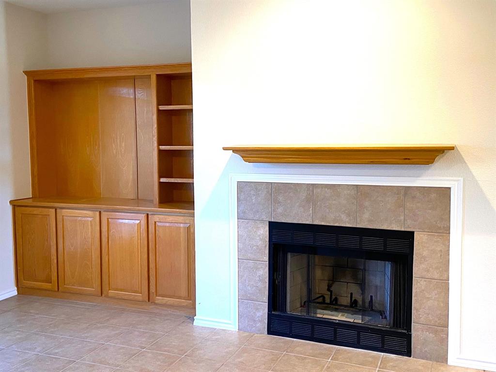 27101 Meadowmore Court Whitney, TX 76692 - Photo 12 of 31 Built in cabinet and wood burning fireplace in the living area.