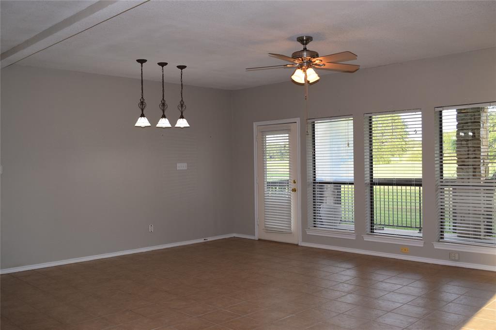27101 Meadowmore Court Whitney, TX 76692 - Photo 5 of 31 a view of an empty room with wooden floor and a window