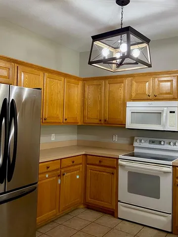 a kitchen with stainless steel appliances granite countertop a stove and a refrigerator