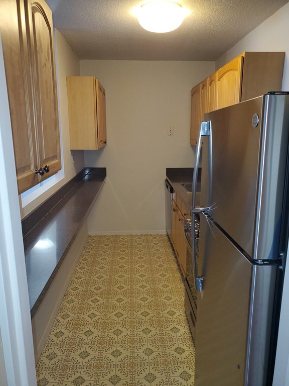 2 Hawthorne Place, Unit 7B Boston, MA 02114 - Photo 5 of 11 a view of a refrigerator in kitchen and an empty room