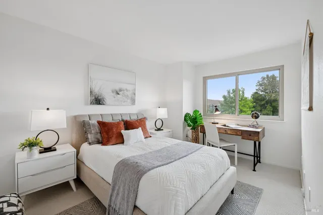 a bedroom with a large bed and a window