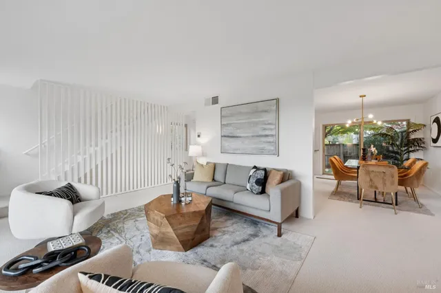 a living room with furniture and a lamp