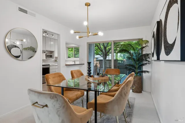 a dining room with furniture a window and a chandelier