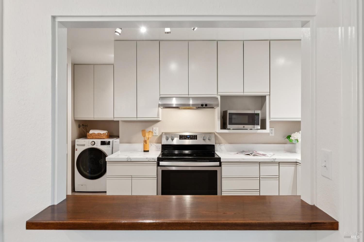 211 Danielle Way San Rafael, CA 94903 - Photo 9 of 33 a kitchen with kitchen island granite countertop stainless steel appliances a stove a sink a refrigerator and cabinets