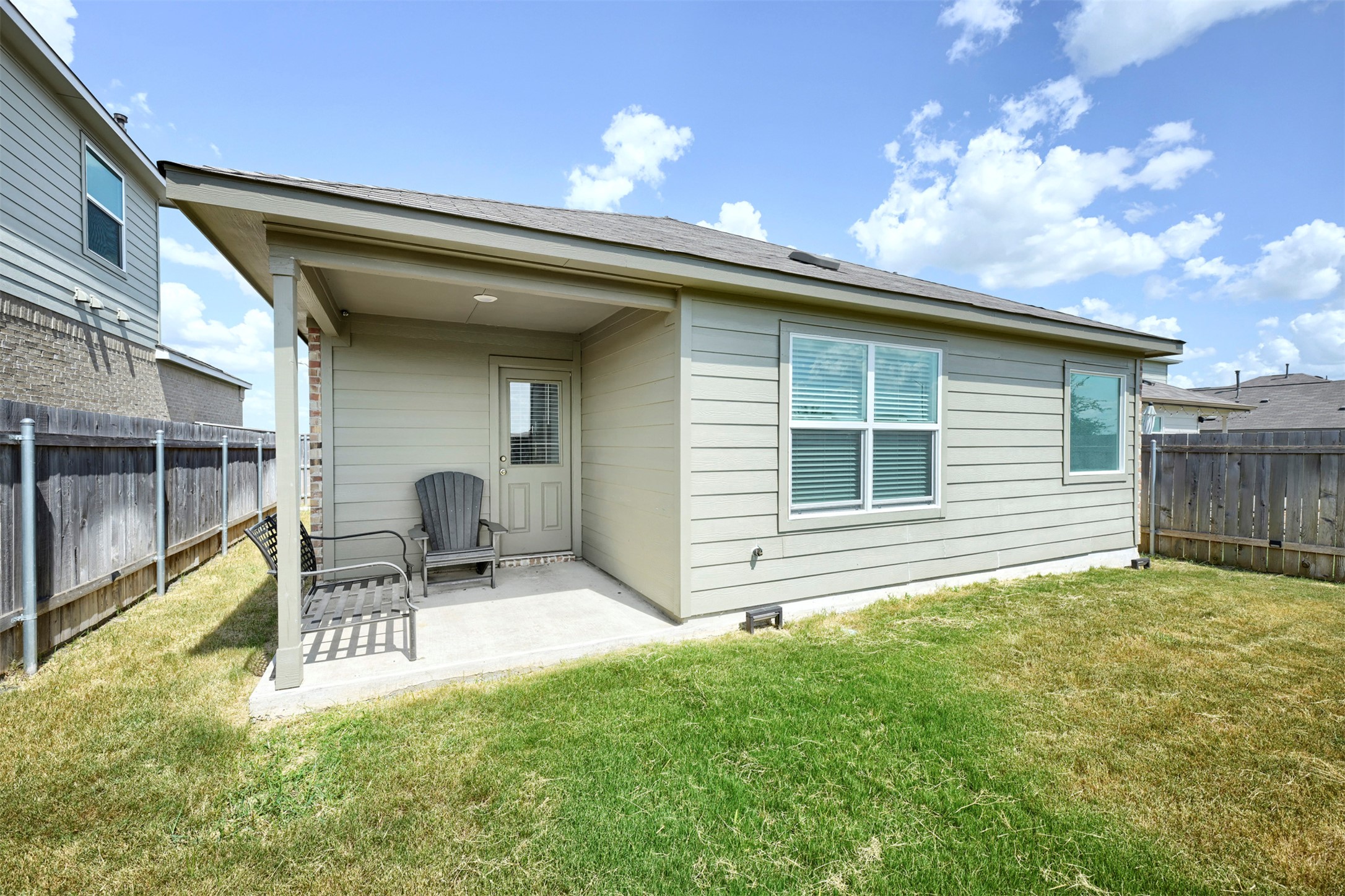 120 Milliner Loop Hutto, TX 78634 - Photo 13 of 15 A private covered patio and verdant lawn extend outdoor living.