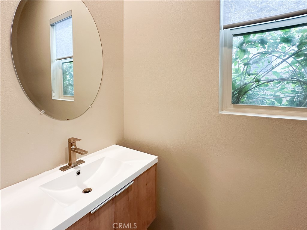 168 Spectacle Irvine, CA 92618 - Photo 14 of 42 a bathroom with a sink and a mirror