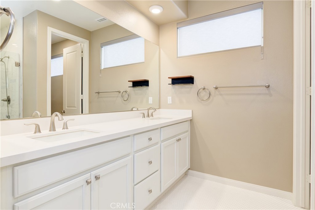 168 Spectacle Irvine, CA 92618 - Photo 21 of 42 a bathroom with a double vanity sink and mirror