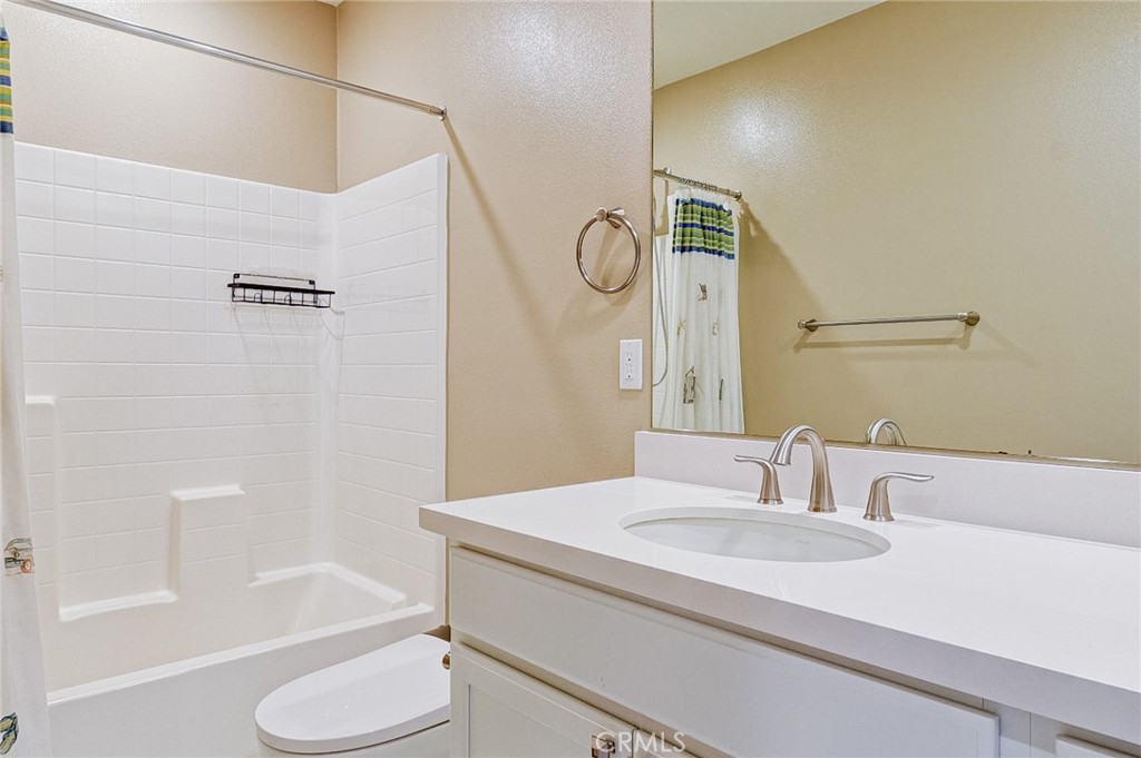 168 Spectacle Irvine, CA 92618 - Photo 30 of 42 a bathroom with a granite countertop sink toilet and shower