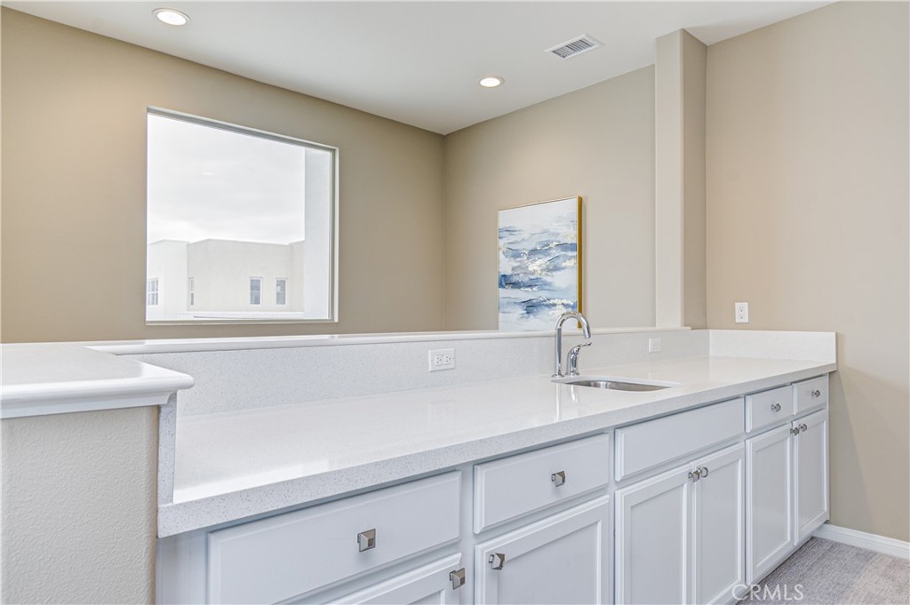168 Spectacle Irvine, CA 92618 - Photo 33 of 42 a bathroom with a sink and a mirror
