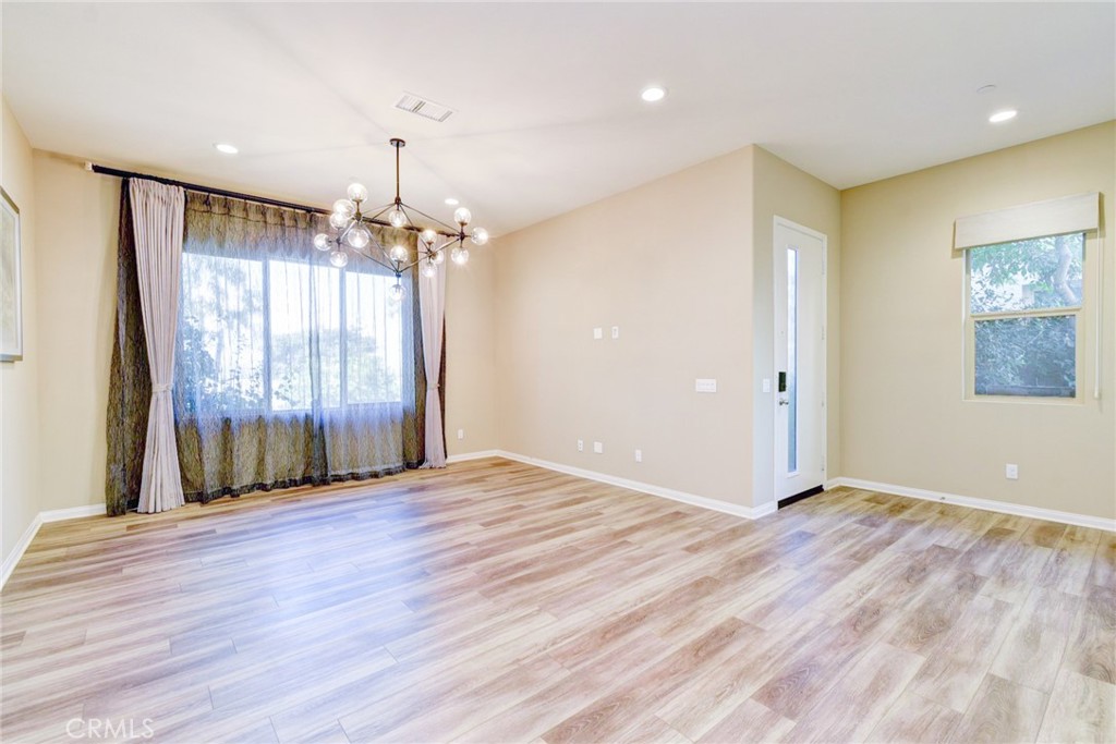 168 Spectacle Irvine, CA 92618 - Photo 5 of 42 an empty room with wooden floor and windows