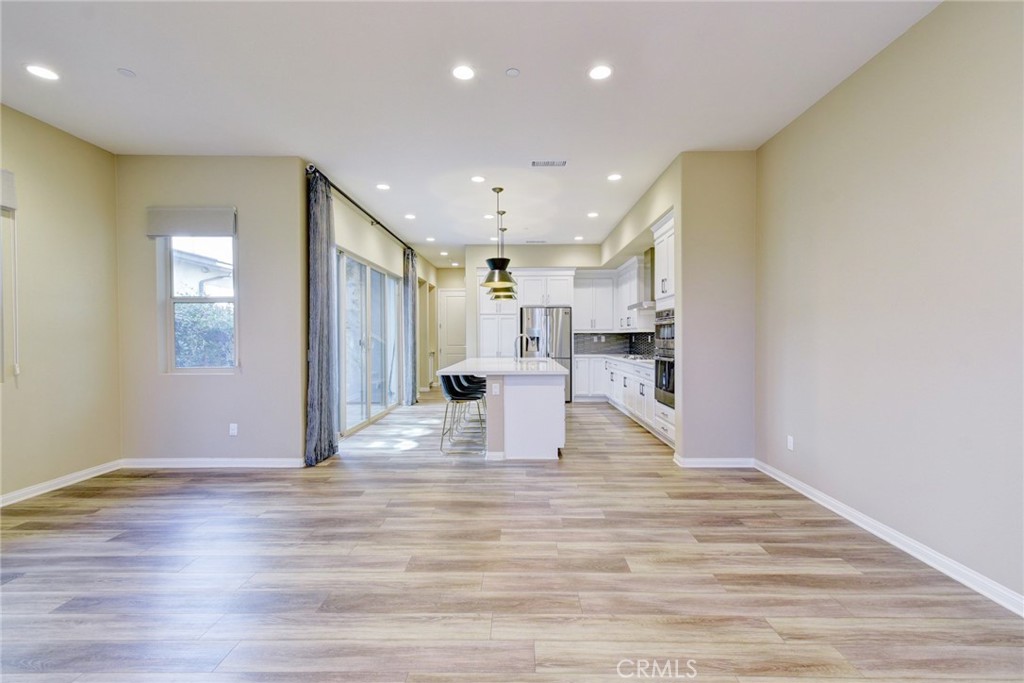 168 Spectacle Irvine, CA 92618 - Photo 6 of 42 a view of kitchen with kitchen island microwave and wooden floor