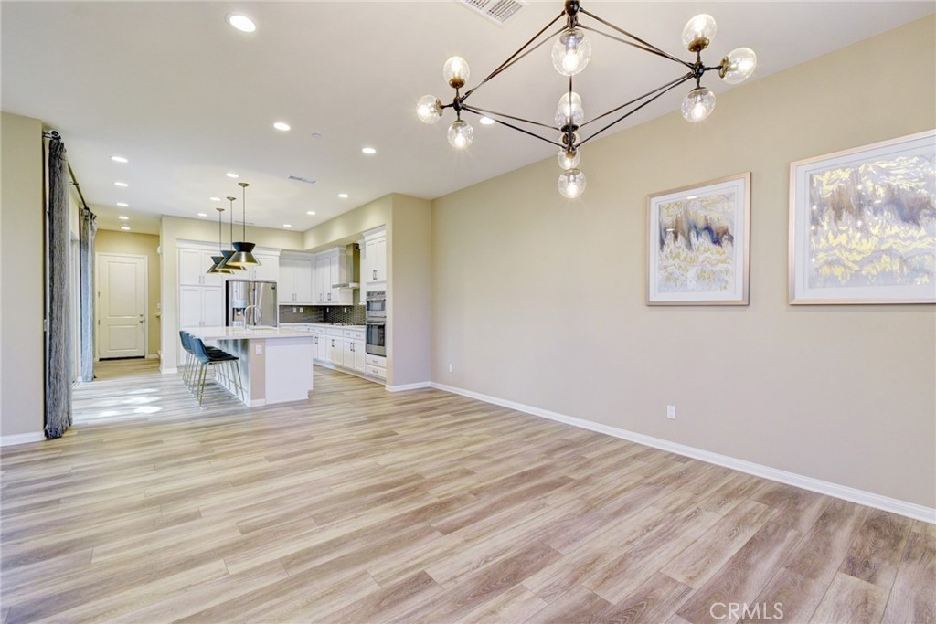 168 Spectacle Irvine, CA 92618 - Photo 8 of 42 a view of a kitchen with wooden floor and a ceiling fan