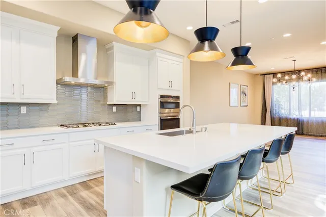 a kitchen with a table chairs and white cabinets