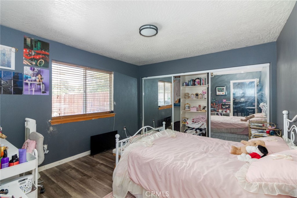 18936 Rock Springs Road Hesperia, CA 92345 - Photo 12 of 28 a bedroom with a bed and wooden floor