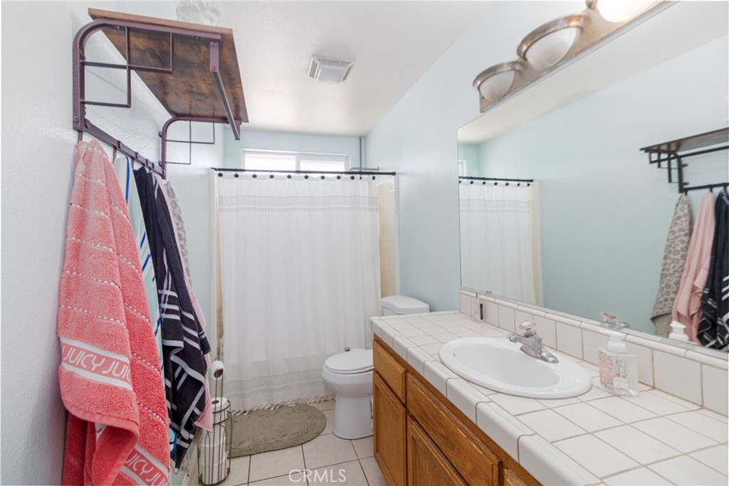 18936 Rock Springs Road Hesperia, CA 92345 - Photo 13 of 28 a bathroom with a sink a toilet and shower