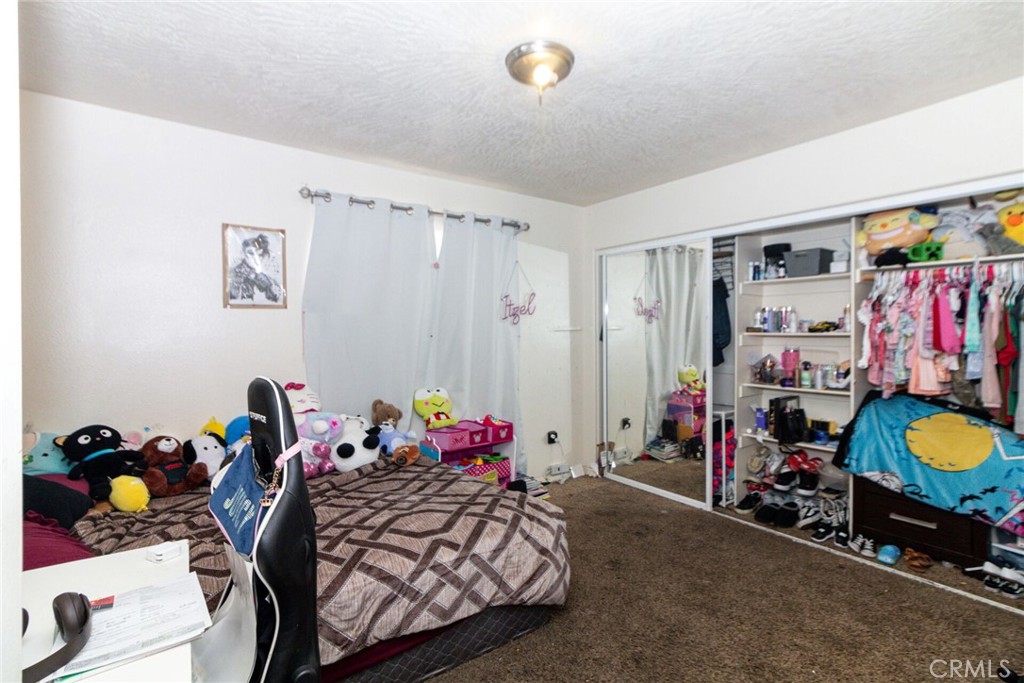 18936 Rock Springs Road Hesperia, CA 92345 - Photo 15 of 28 a bed room with a bed and a window