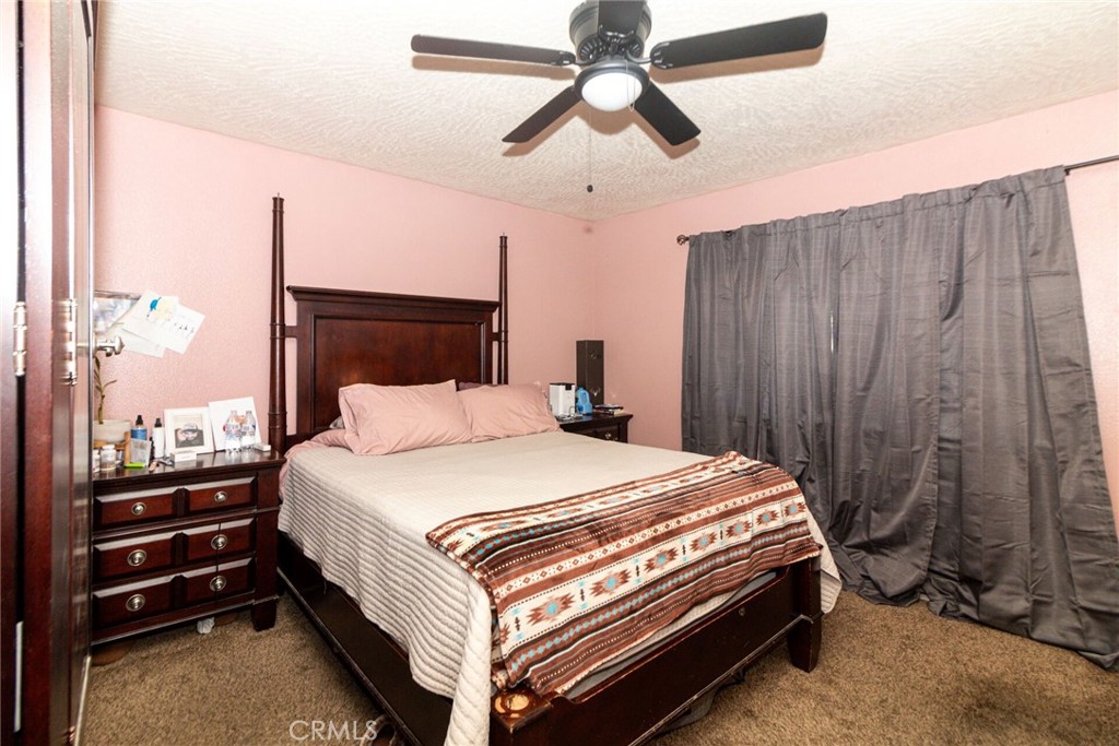 18936 Rock Springs Road Hesperia, CA 92345 - Photo 16 of 28 a bed sitting in a bedroom next to a window