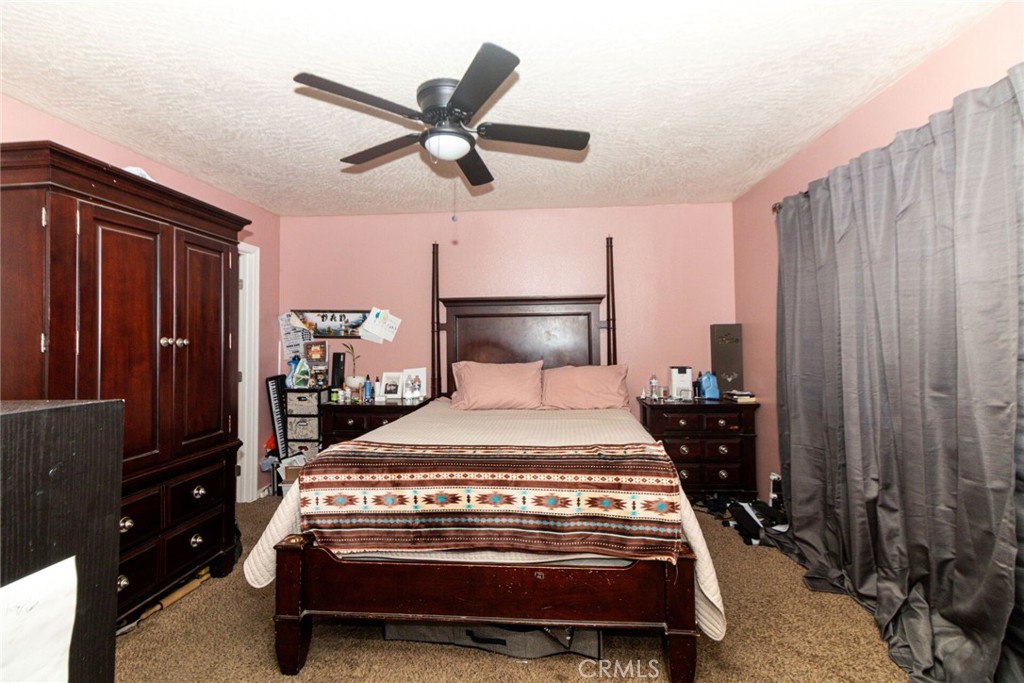 18936 Rock Springs Road Hesperia, CA 92345 - Photo 17 of 28 a bedroom with a bed and a closet