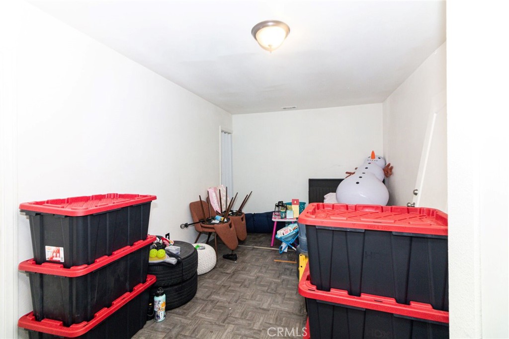 18936 Rock Springs Road Hesperia, CA 92345 - Photo 21 of 28 a bedroom with furniture and a chandelier