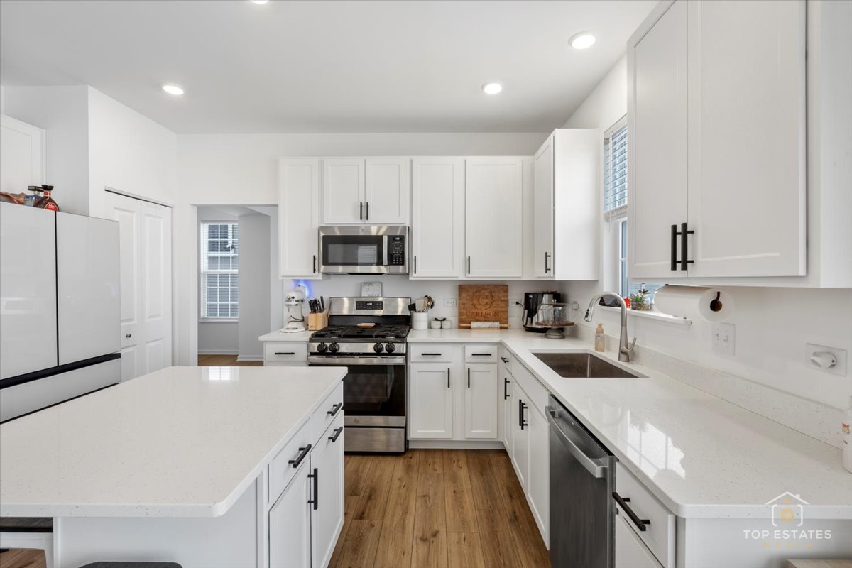 1457 Collins Street Elburn, IL 60119 - Photo 13 of 39 a kitchen with appliances a sink and cabinets