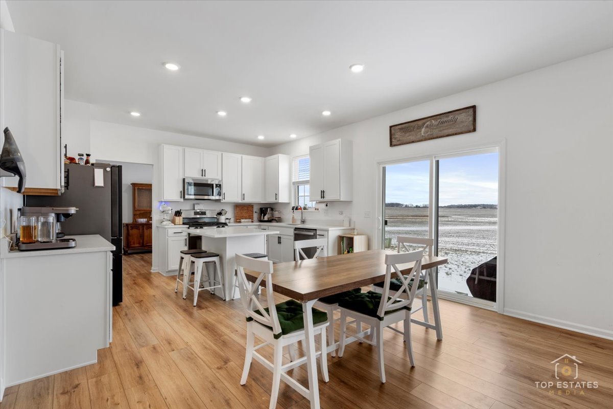 1457 Collins Street Elburn, IL 60119 - Photo 14 of 39 a view of a dining room with furniture window and wooden floor