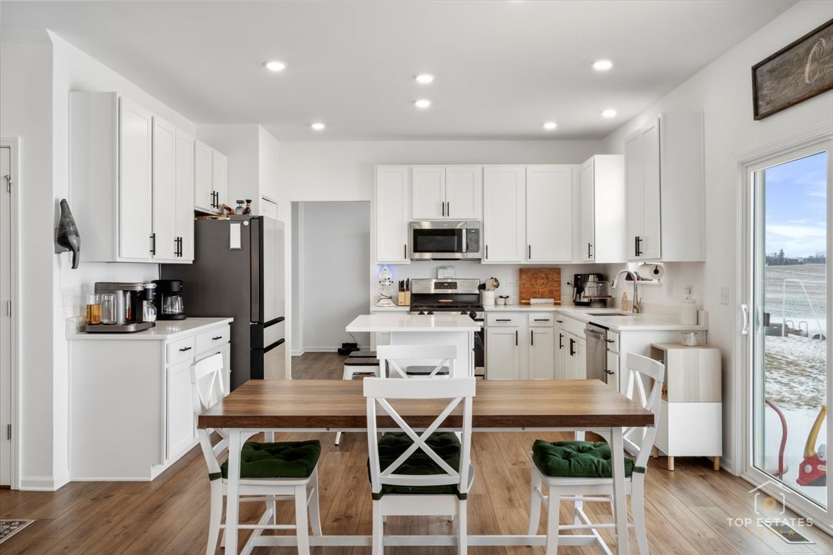 1457 Collins Street Elburn, IL 60119 - Photo 15 of 39 a kitchen with stainless steel appliances a stove a refrigerator sink and cabinets