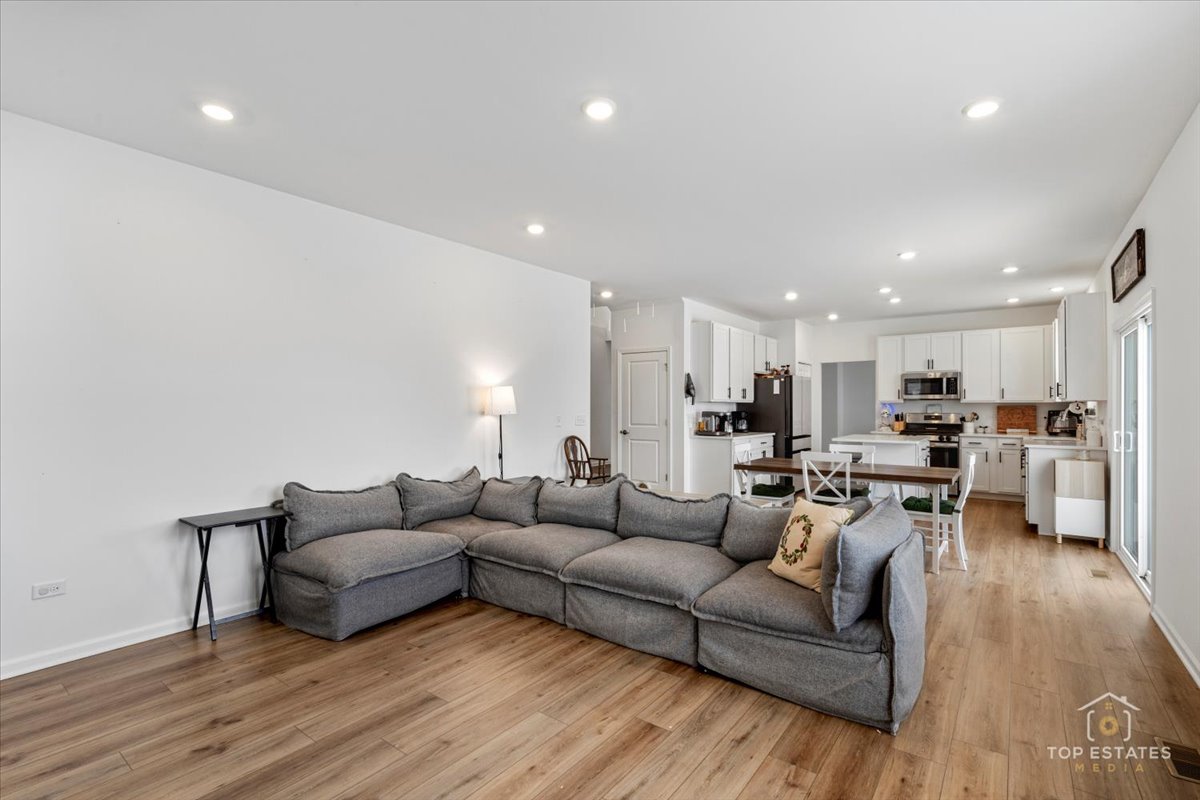 1457 Collins Street Elburn, IL 60119 - Photo 22 of 39 a living room with furniture and a wooden floor