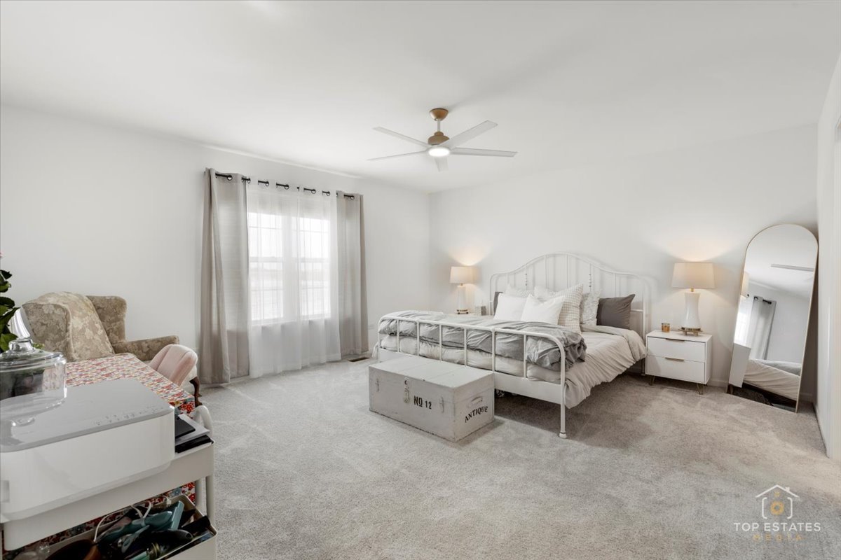 1457 Collins Street Elburn, IL 60119 - Photo 27 of 39 a bedroom with a bed and a chandelier