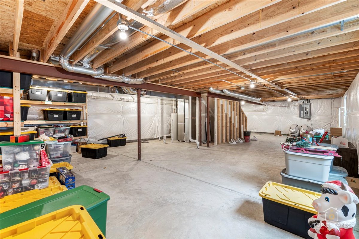 1457 Collins Street Elburn, IL 60119 - Photo 34 of 39 a storage room with lots of furniture and clutter