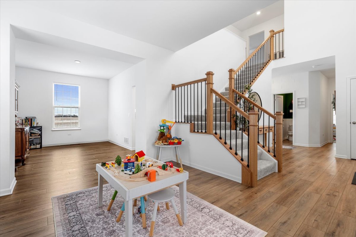 1457 Collins Street Elburn, IL 60119 - Photo 8 of 39 a room with furniture and stairs