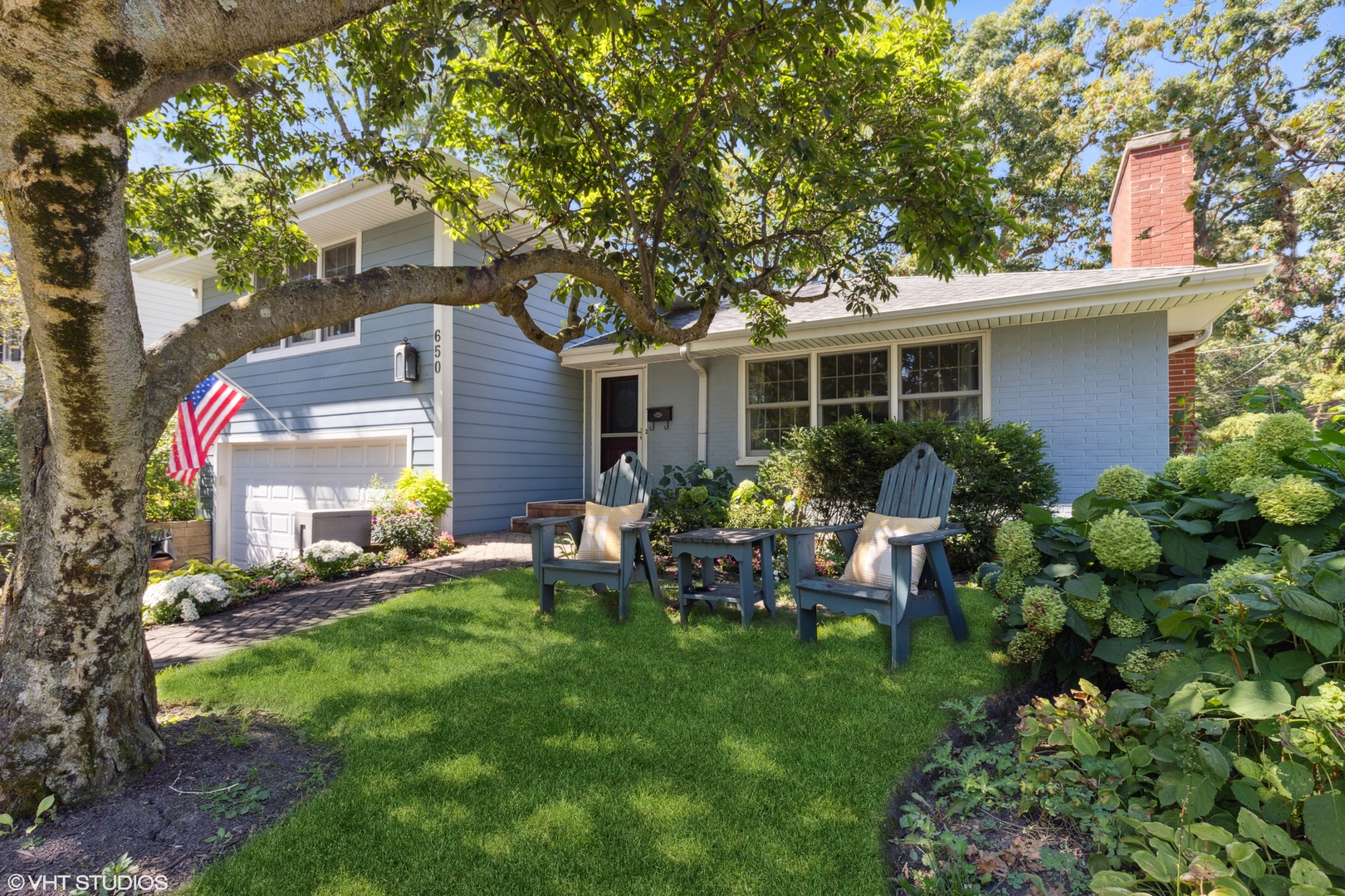 a view of a house with backyard sitting area and garden