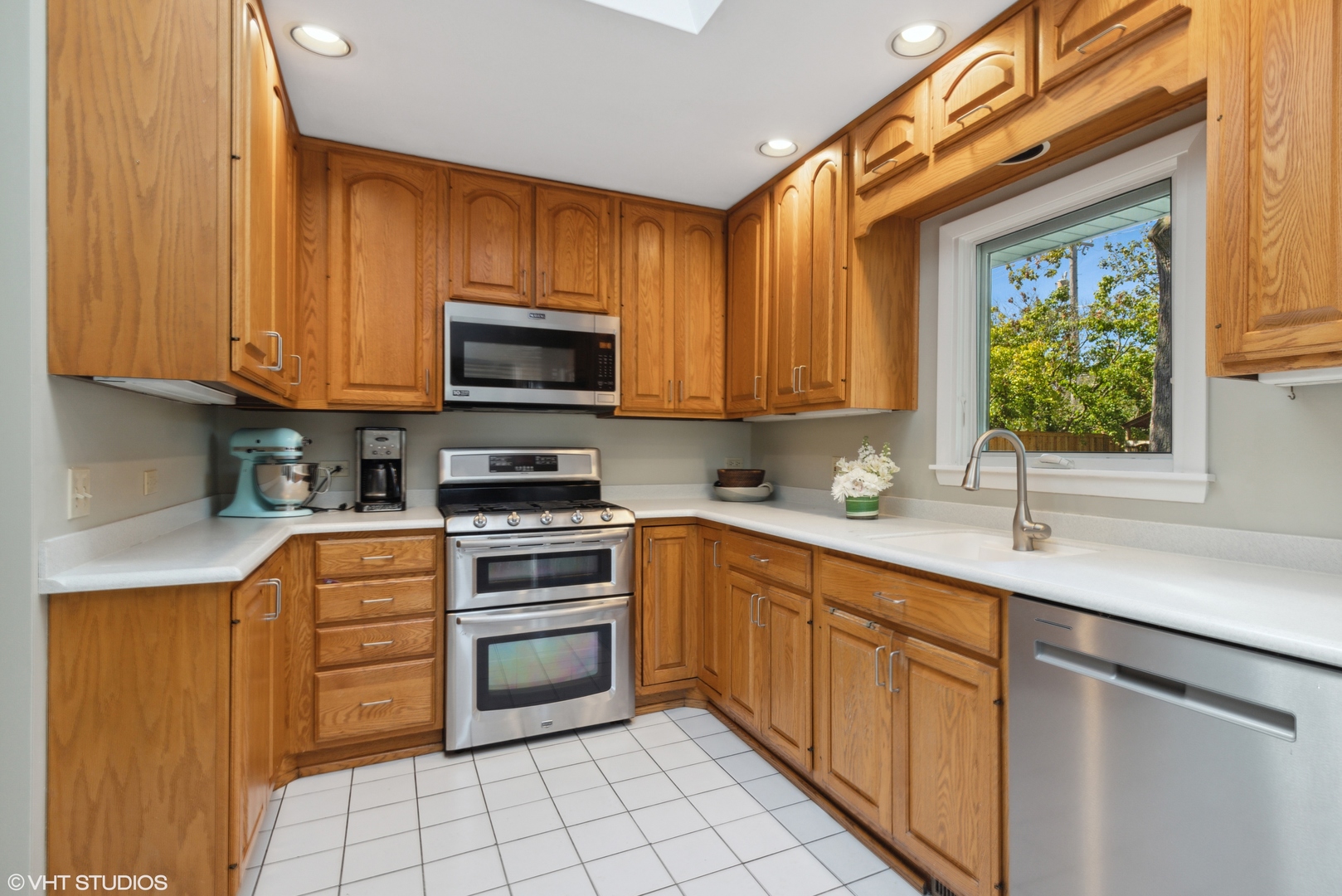 650 Garfield Avenue Lake Bluff, IL 60044 - Photo 7 of 25 a kitchen with stainless steel appliances granite countertop a sink a stove a microwave and cabinets