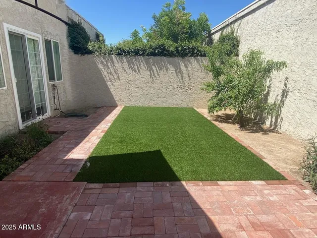 a swimming pool with outdoor seating outdoor seating and yard