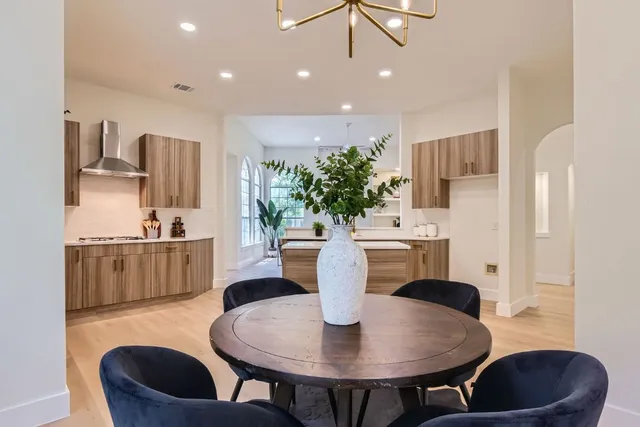 a living room with kitchen and a table
