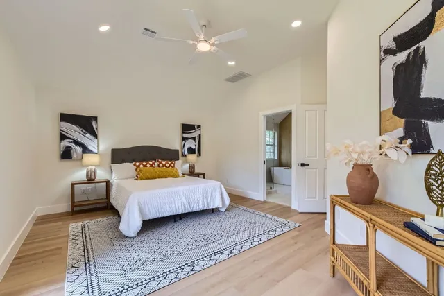 a bedroom with a bed and wooden floor