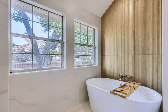 a white bath tub sitting next to a window