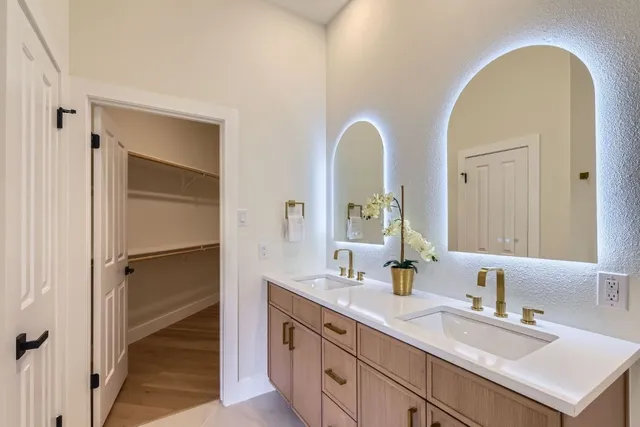a bathroom with a double vanity sink and a mirror