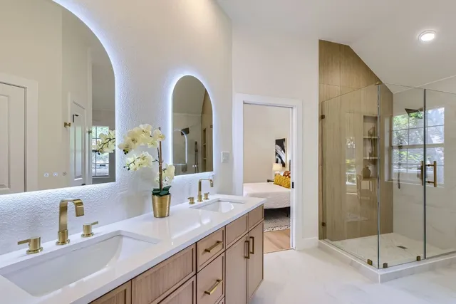 a en suite bathroom with a granite countertop sink mirror and shower