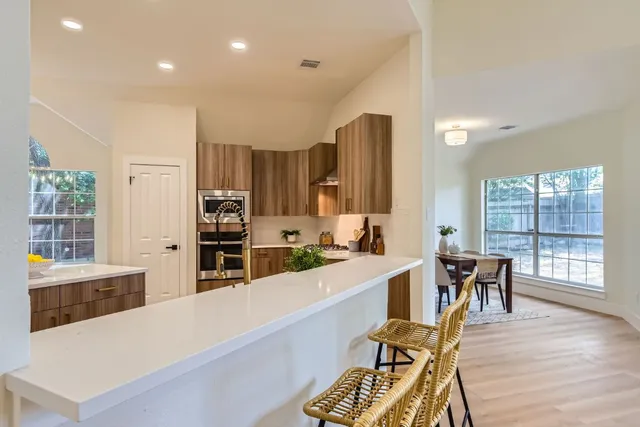 a large kitchen with lots of counter space and windows