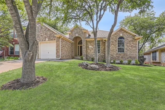 a front view of house with yard and green space