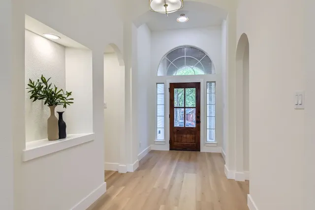 wooden floor in an empty room with a window