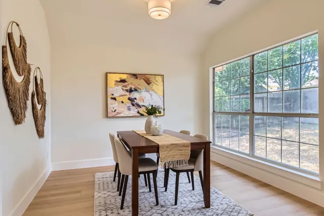 a dining room with furniture and a window