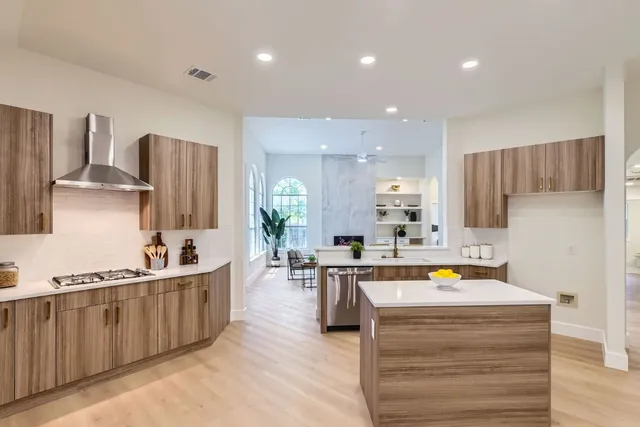 a large kitchen with kitchen island a sink stainless steel appliances and cabinets