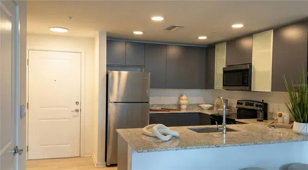 a kitchen with refrigerator and microwave