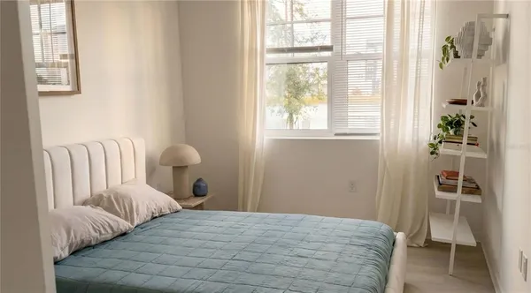 a bedroom with a bed and a window
