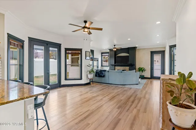 a kitchen with stainless steel appliances kitchen island granite countertop a refrigerator and a stove top oven