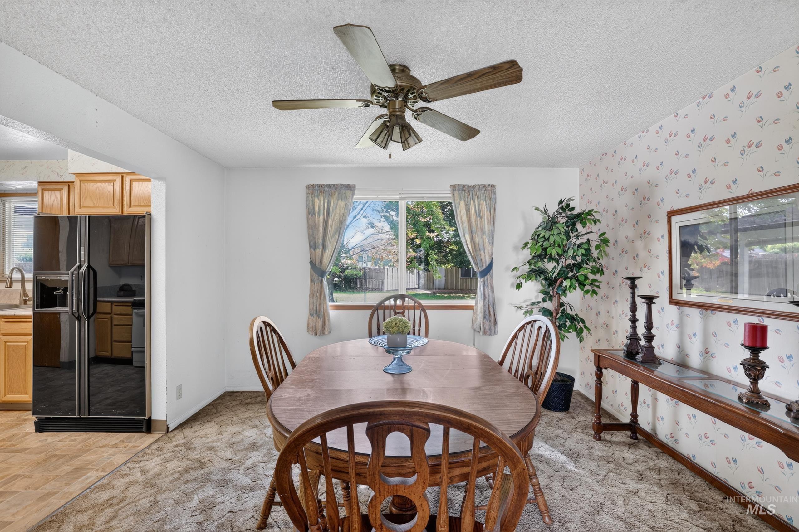 9055 West Highlander Road Boise, ID 83709 - Photo 9 of 39 Dining area with ceiling fan, dedicated window, and adjacent kitchen entry